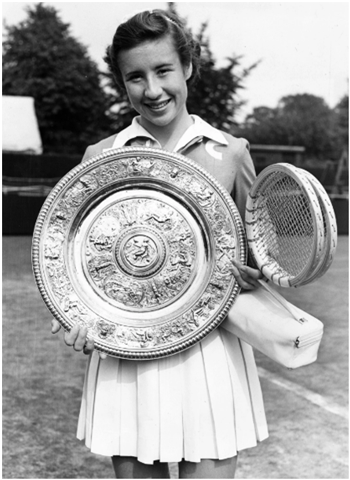 Maureen Connolly holding trophy plate on tennis court